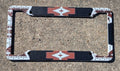 Decorative license plate frame with Tan  aztec pattern on a concrete surface