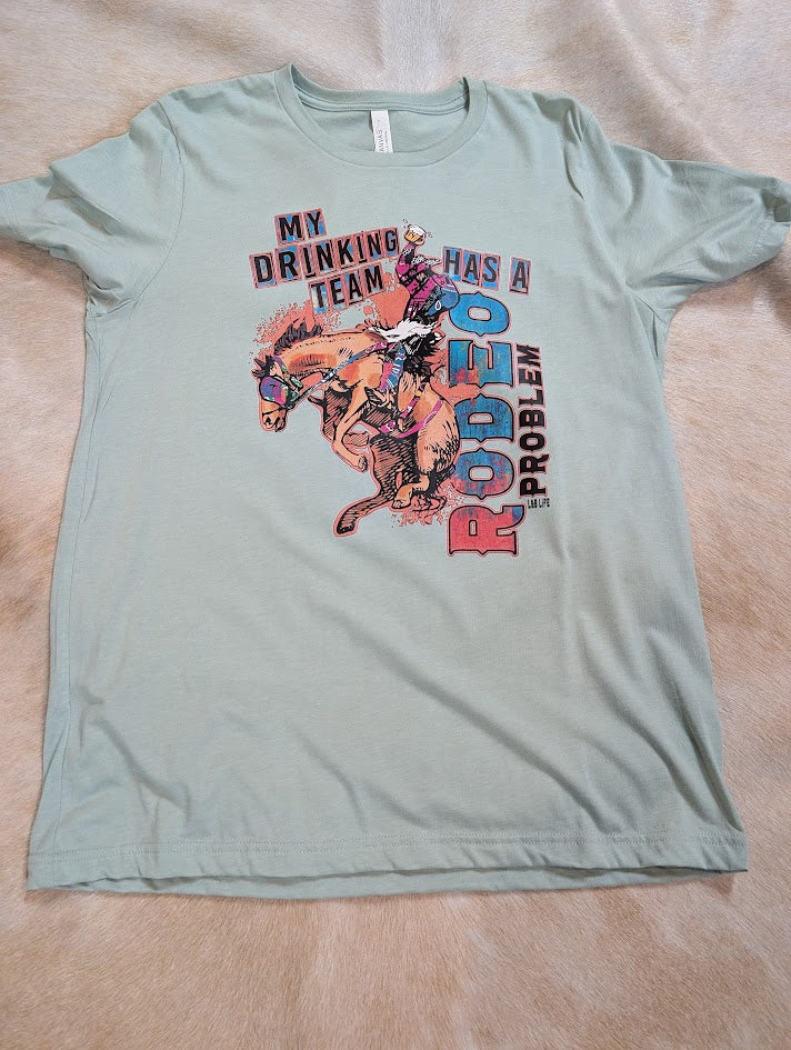Light green t-shirt with graphic design and text on a beige surface