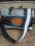 Handbag with leather design and gray body on a textured surface