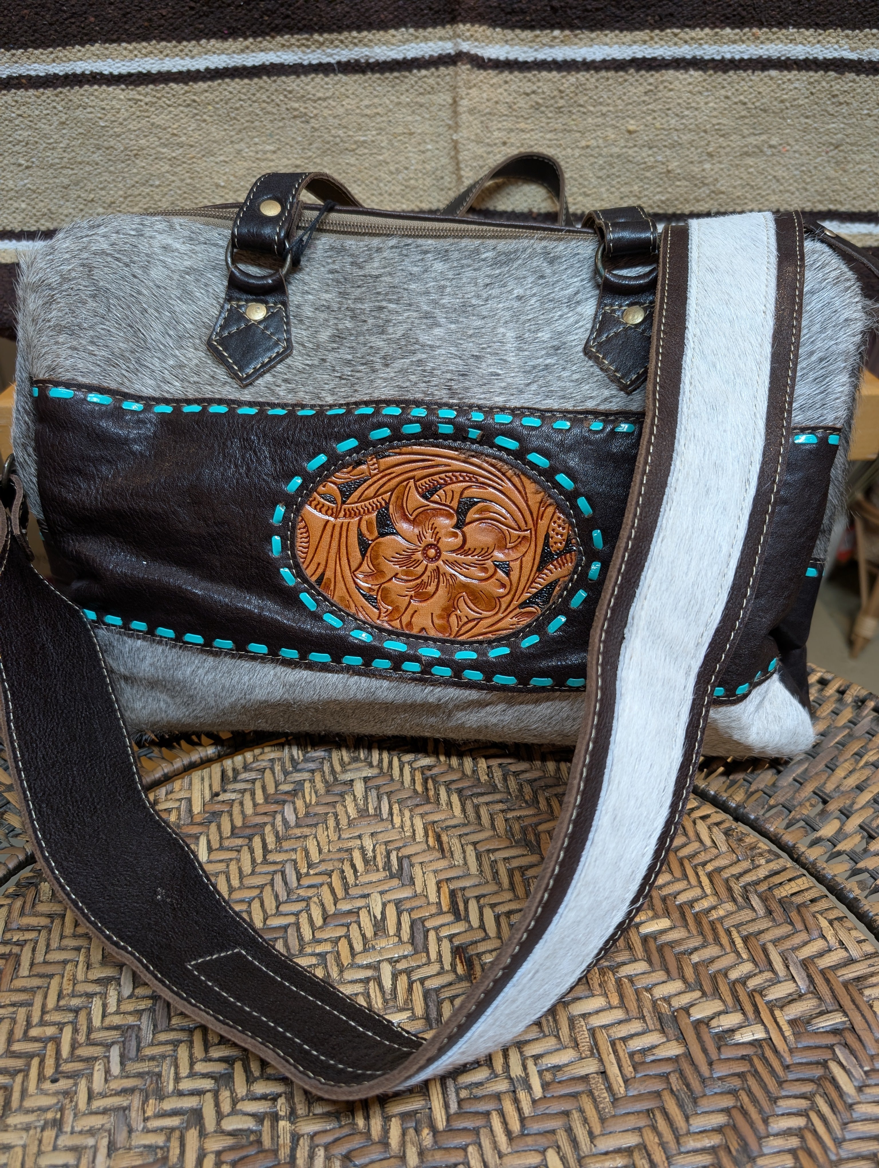 Handbag with leather design and gray body on a textured surface