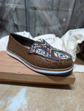 Myra Women’s Tooled Leather & Aztec Slip-On Shoes on a wood table 