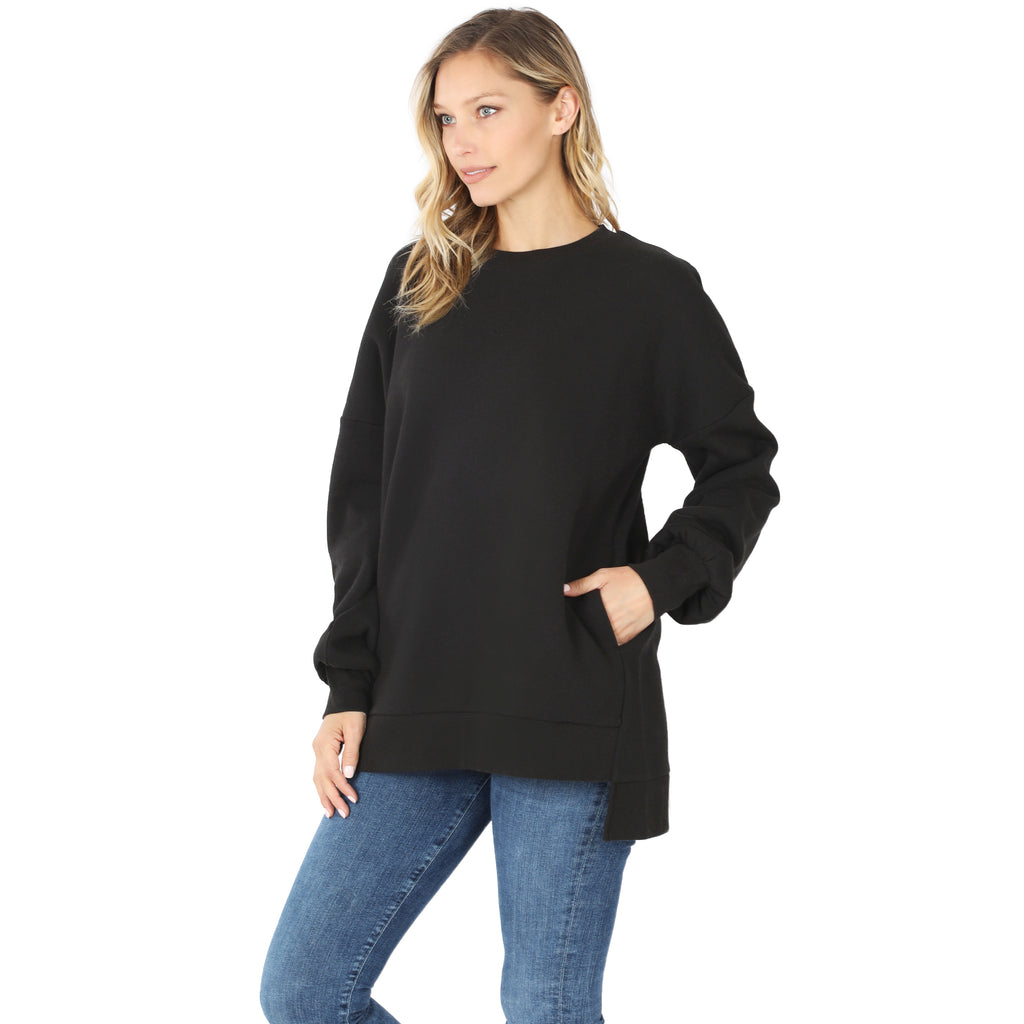 Woman wearing a black sweater and blue jeans on a white background