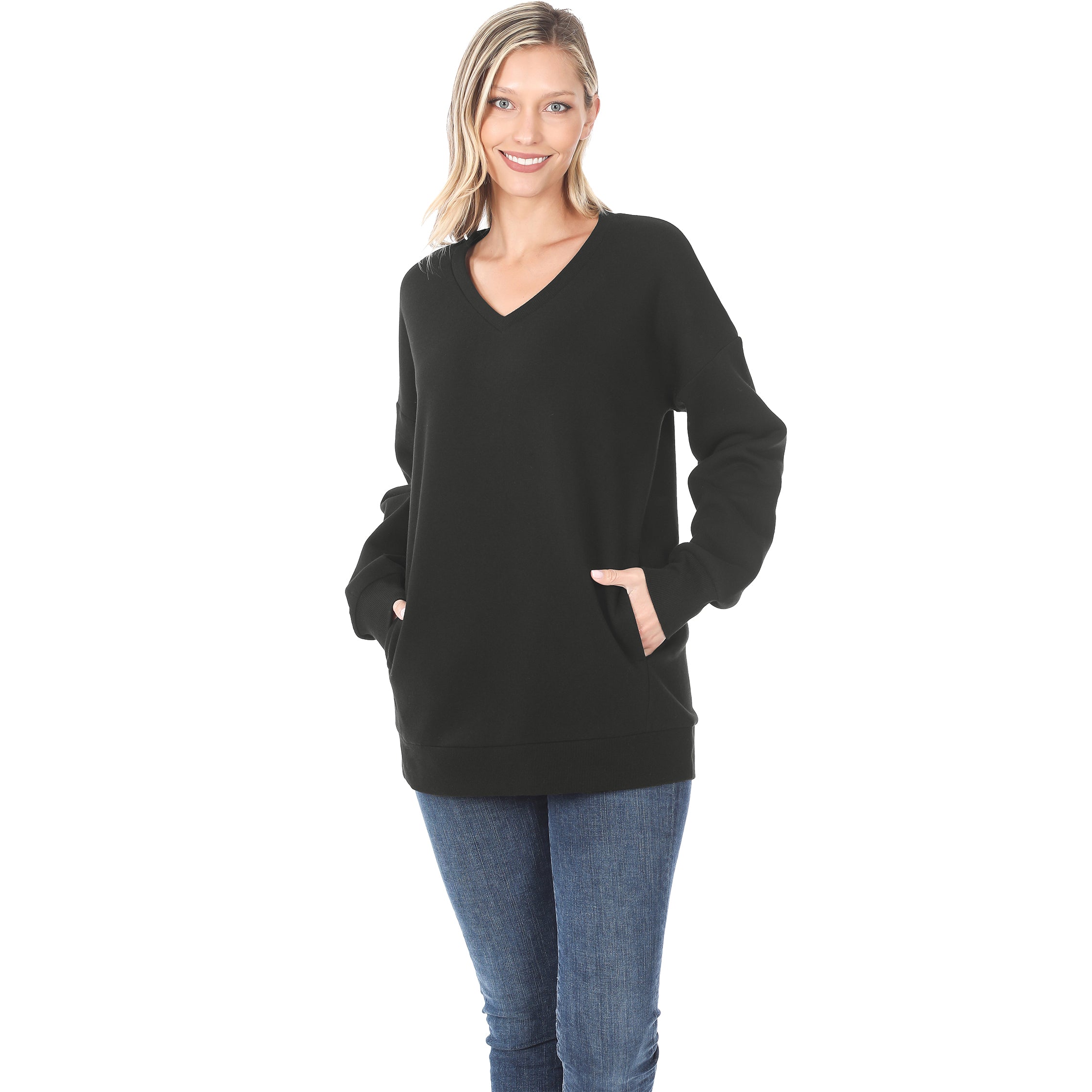 Woman wearing a black sweater and blue jeans on a white background