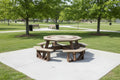 Octagonal picnic table with benches in a park setting