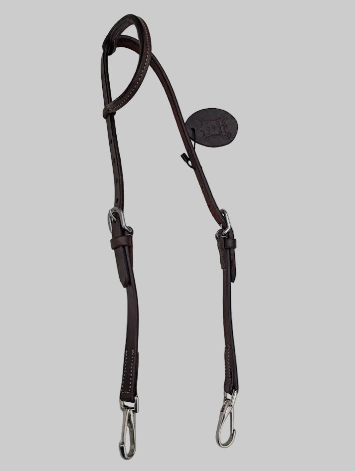 Brown leather bridle on a light gray background