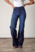 Lady wearing Kimes Ranch Dark wash olivia jeans with a white shirt and gray background