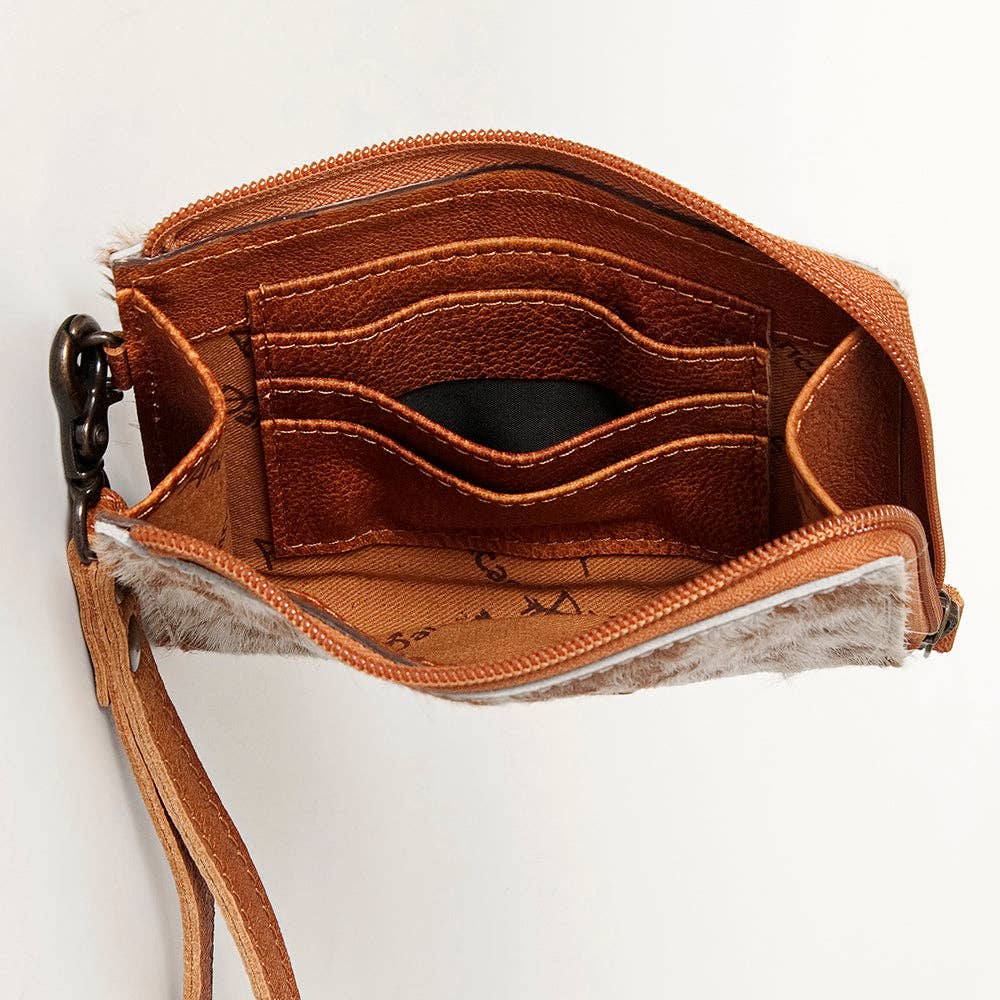 Brown leather handbag with visible stitching on a white background