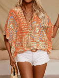 Woman wearing orange boho v-neck blouse with vibrant pattern