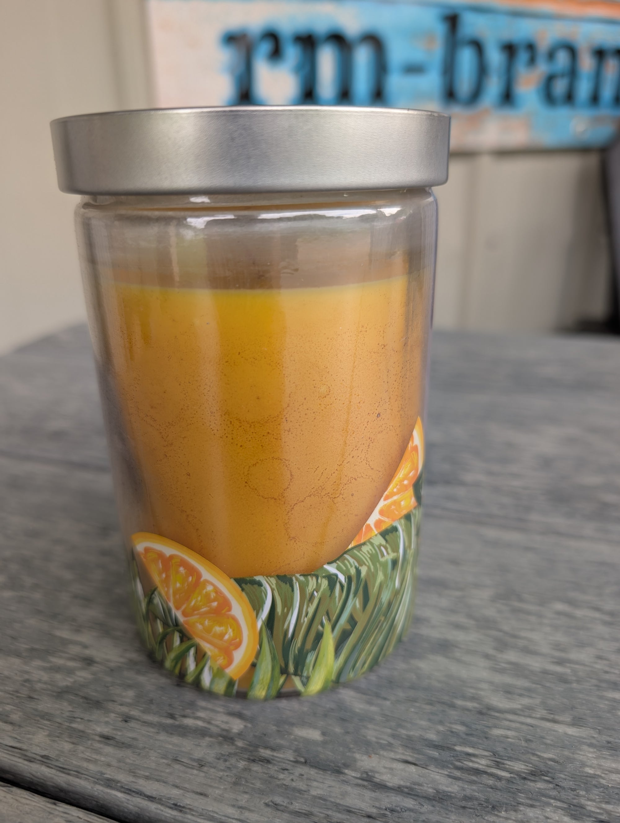 Orange cream scented 16oz candle in glass jar, single wick for cozy burn."