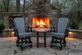 two gray and black swivel chairs and table by a fire. 