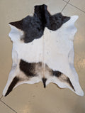 A genuine goat hide with a black and white pattern, laid flat on a surface.