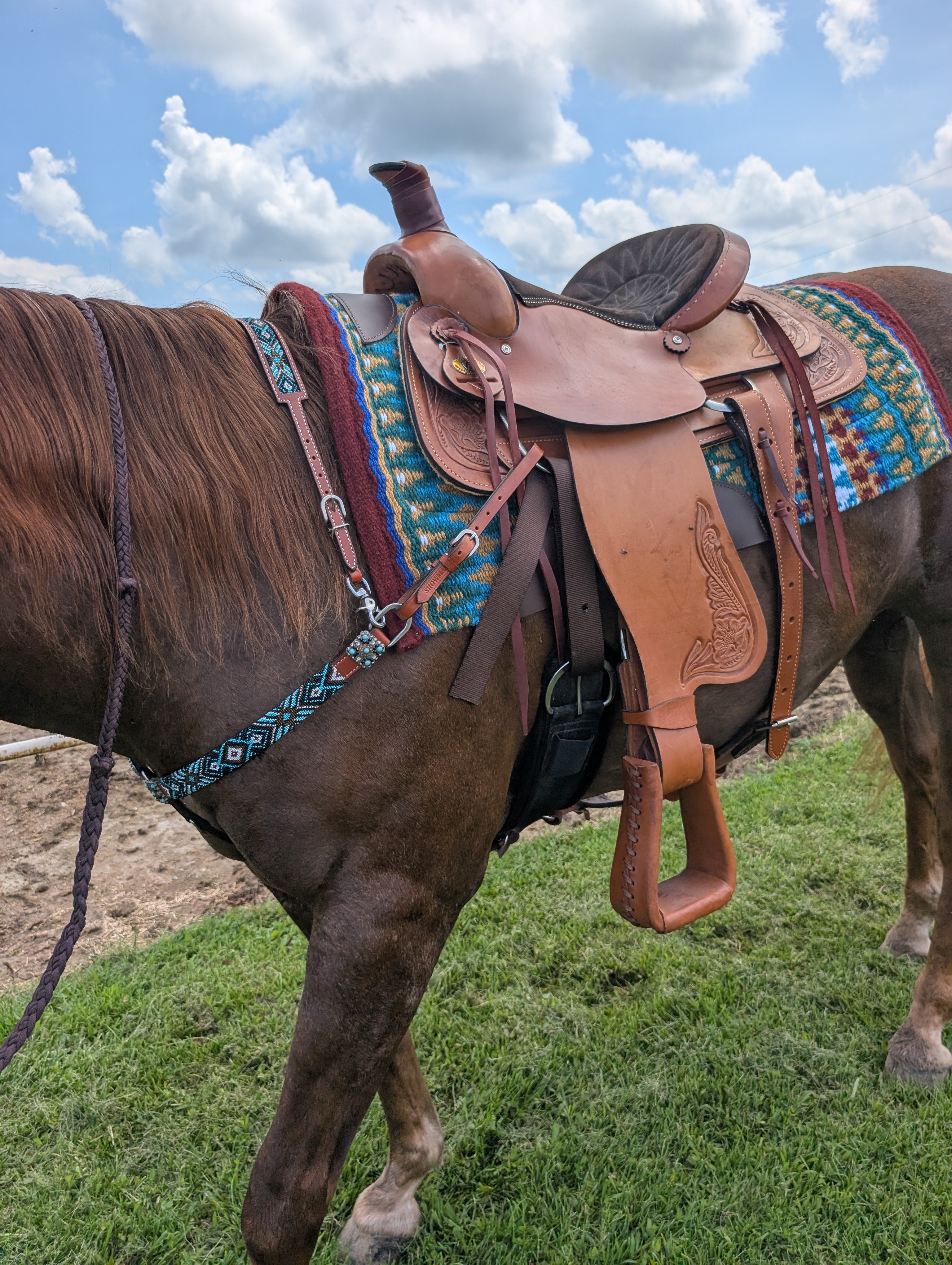 New Circle A 16-inch leather roping saddle with sturdy horn, reinforced stirrups, and western tooling, designed for arena or cattle work.