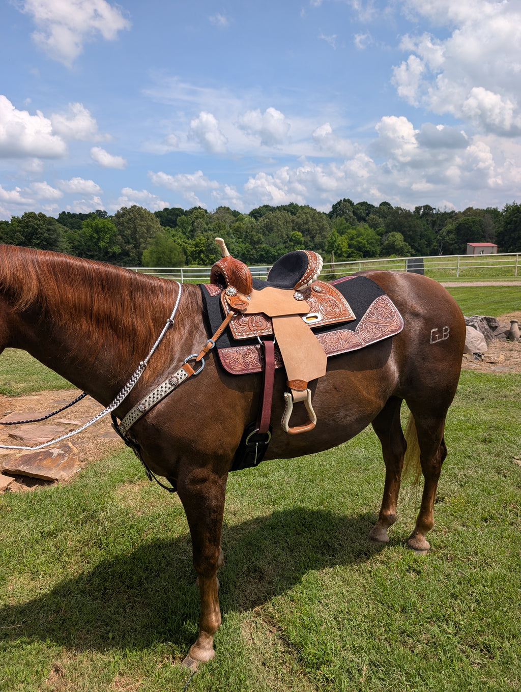 Western barrel racing saddle by Stockyard Saddlery, 12-inch high back design with hand-tooled leather and buckstitch detail.