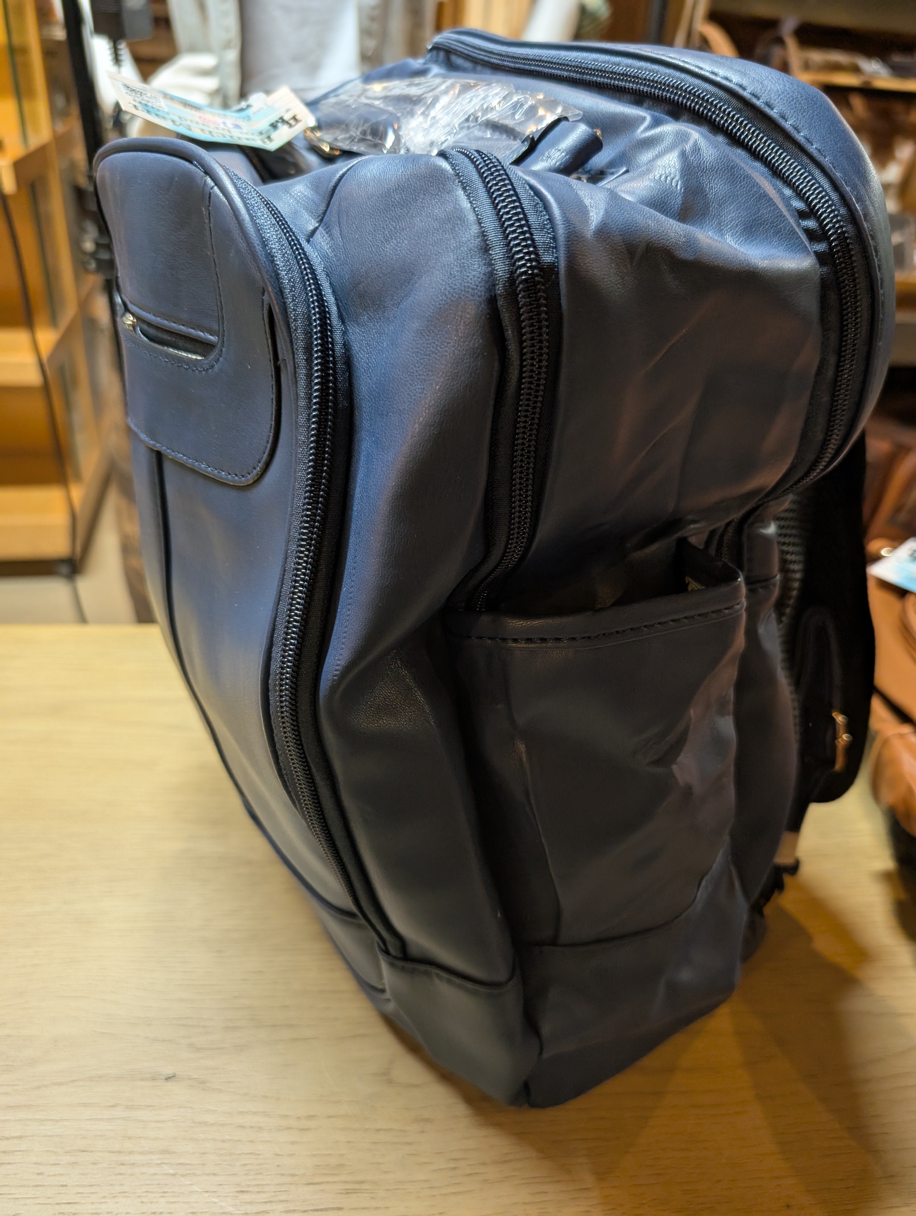 Closeup of Montana West water-resistant PVC leather backpack featuring western detailing and adjustable straps