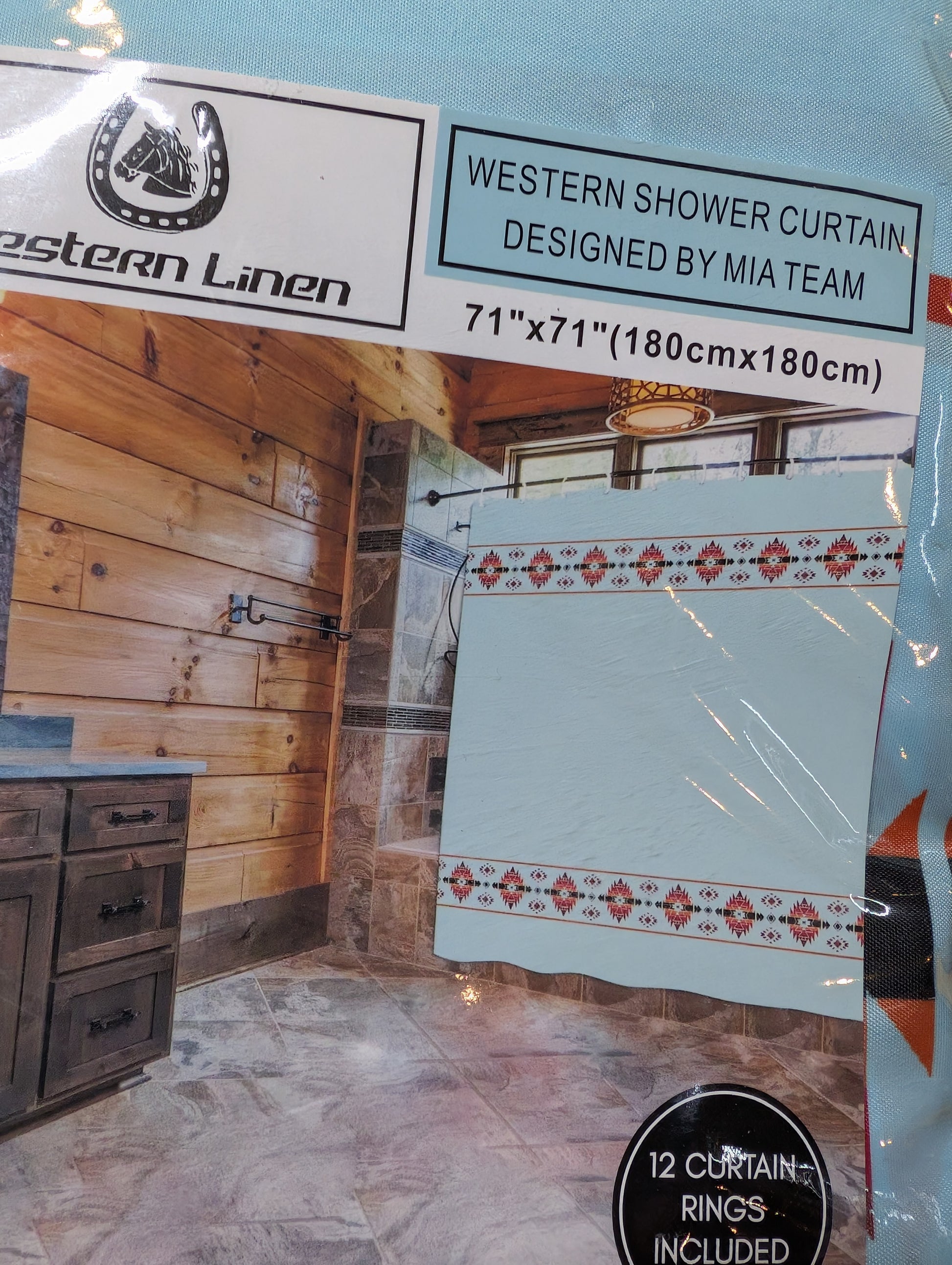 Western-style fabric shower curtain with traditional patterns, installed with rings in a country-style bathroom.