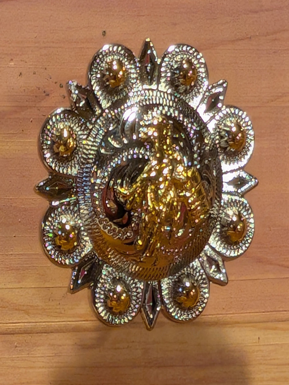 Assorted western drawer knobs featuring star and horseshoe designs in rustic finishes on wooden surface.
