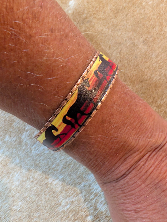 Wrist wearing a colorful bracelet on a textured surface