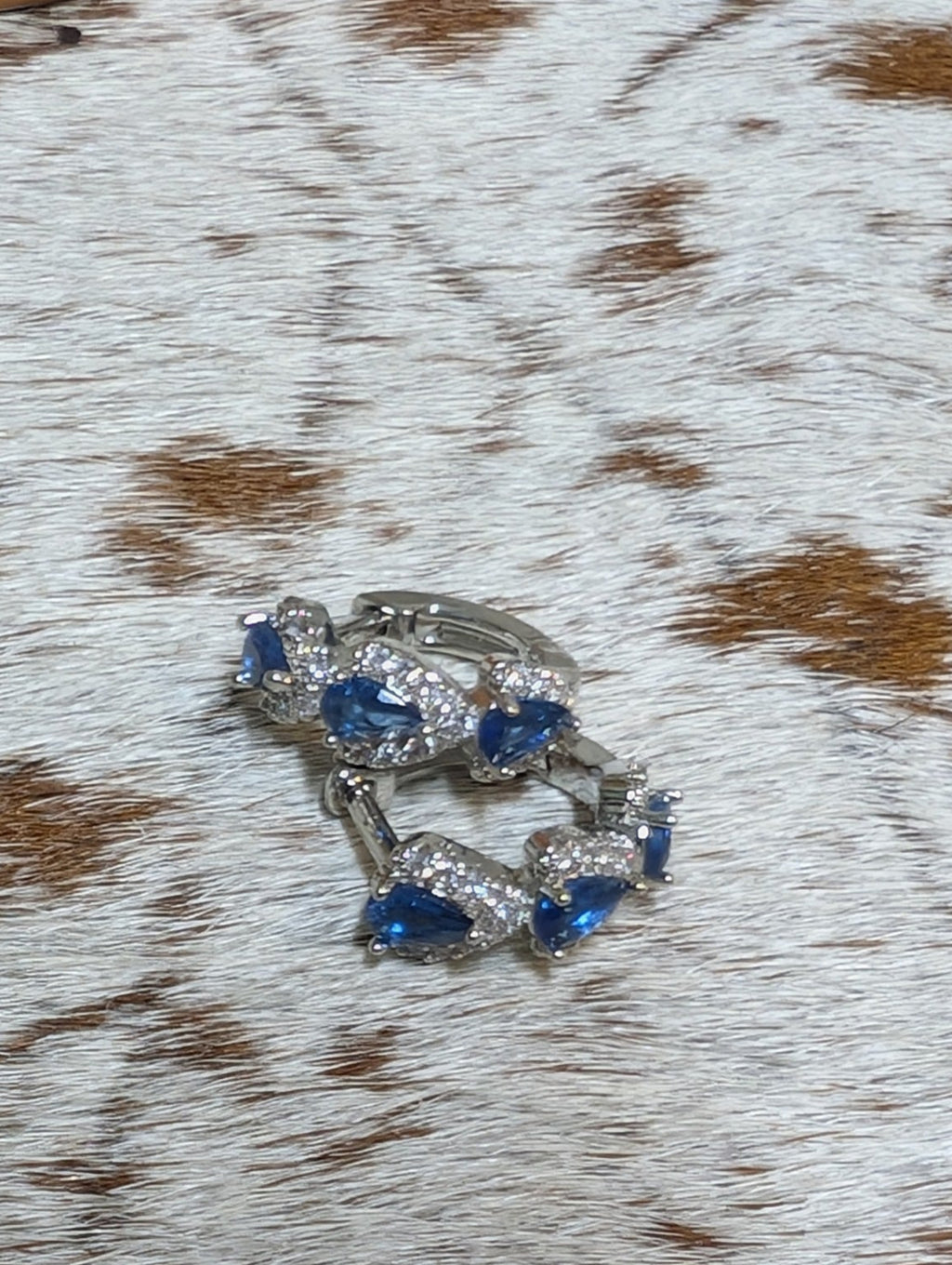 Close-up of a decorative ring on a textured surface with brown and white pattern