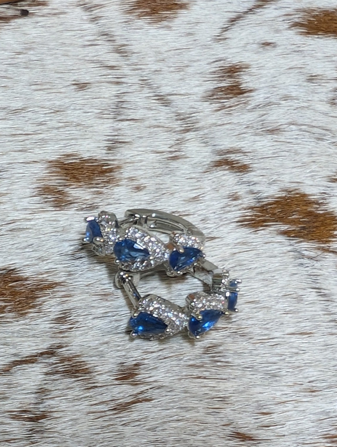 Close-up of a decorative ring on a textured surface with brown and white pattern