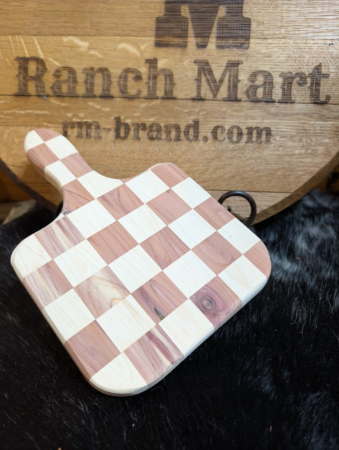 Checkered wooden cutting board on a dark surface with 'Ranch Mart' branding in the background.