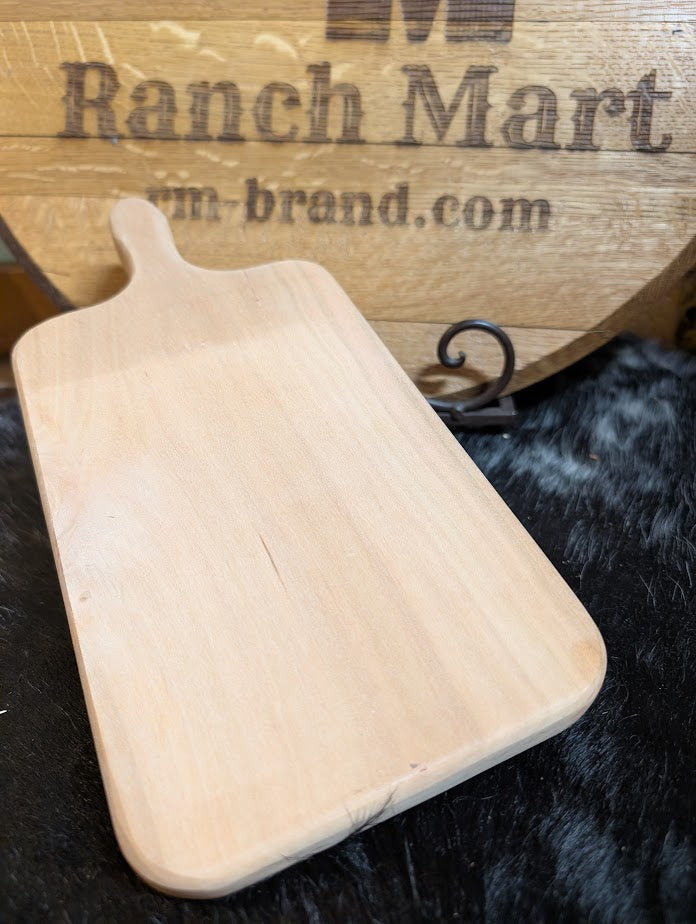 Wooden cutting board on a dark surface with 'Ranch Mart' branding in the background.