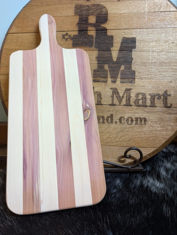 Wooden cutting board with striped pattern on a wooden surface with 'RM Mart' branding.