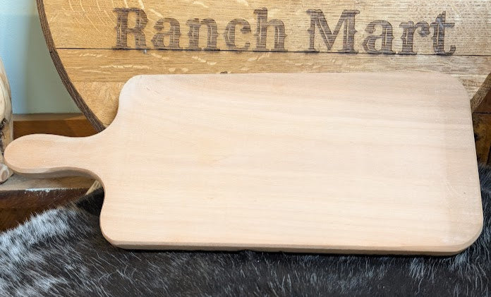 Wooden cutting board with 'Ranch Mart' branding on a dark surface