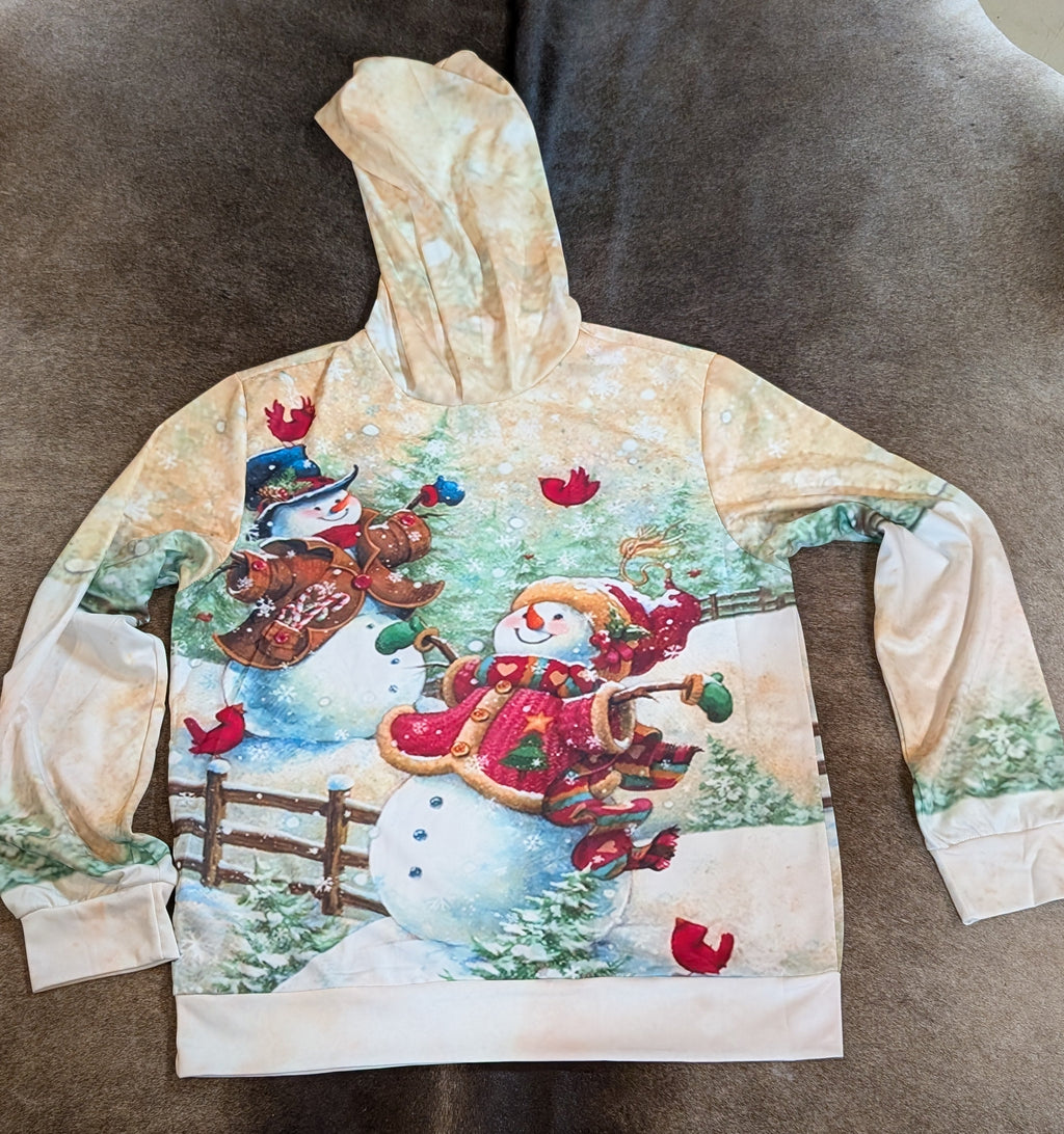 Hoodie with a festive design of snowmen and winter elements on a brown surface