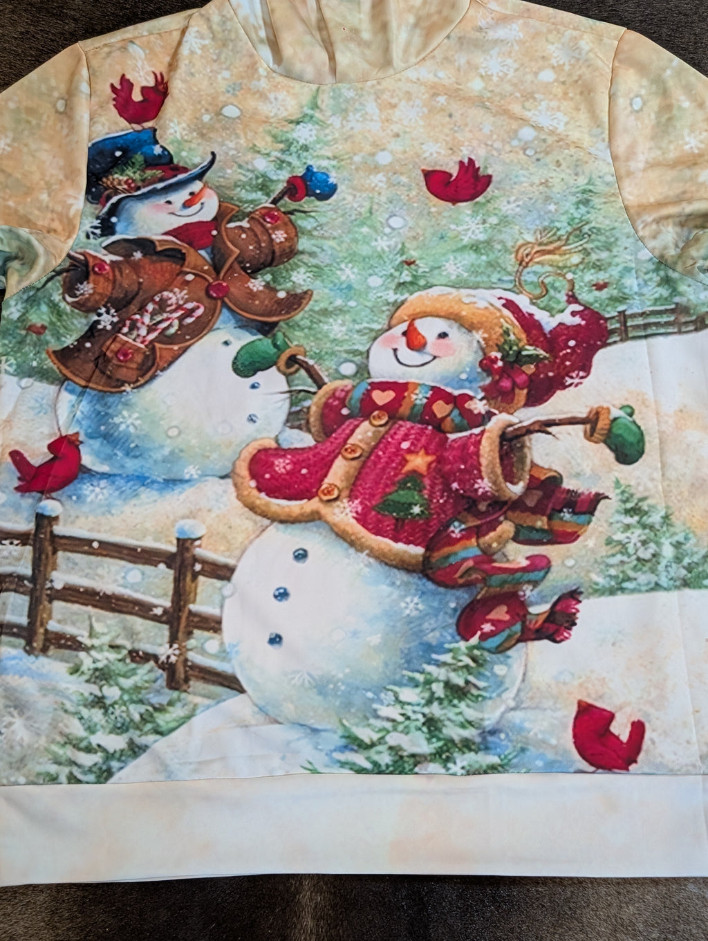 Decorative quilt with a snowman design featuring a red scarf and boots, surrounded by winter elements.
