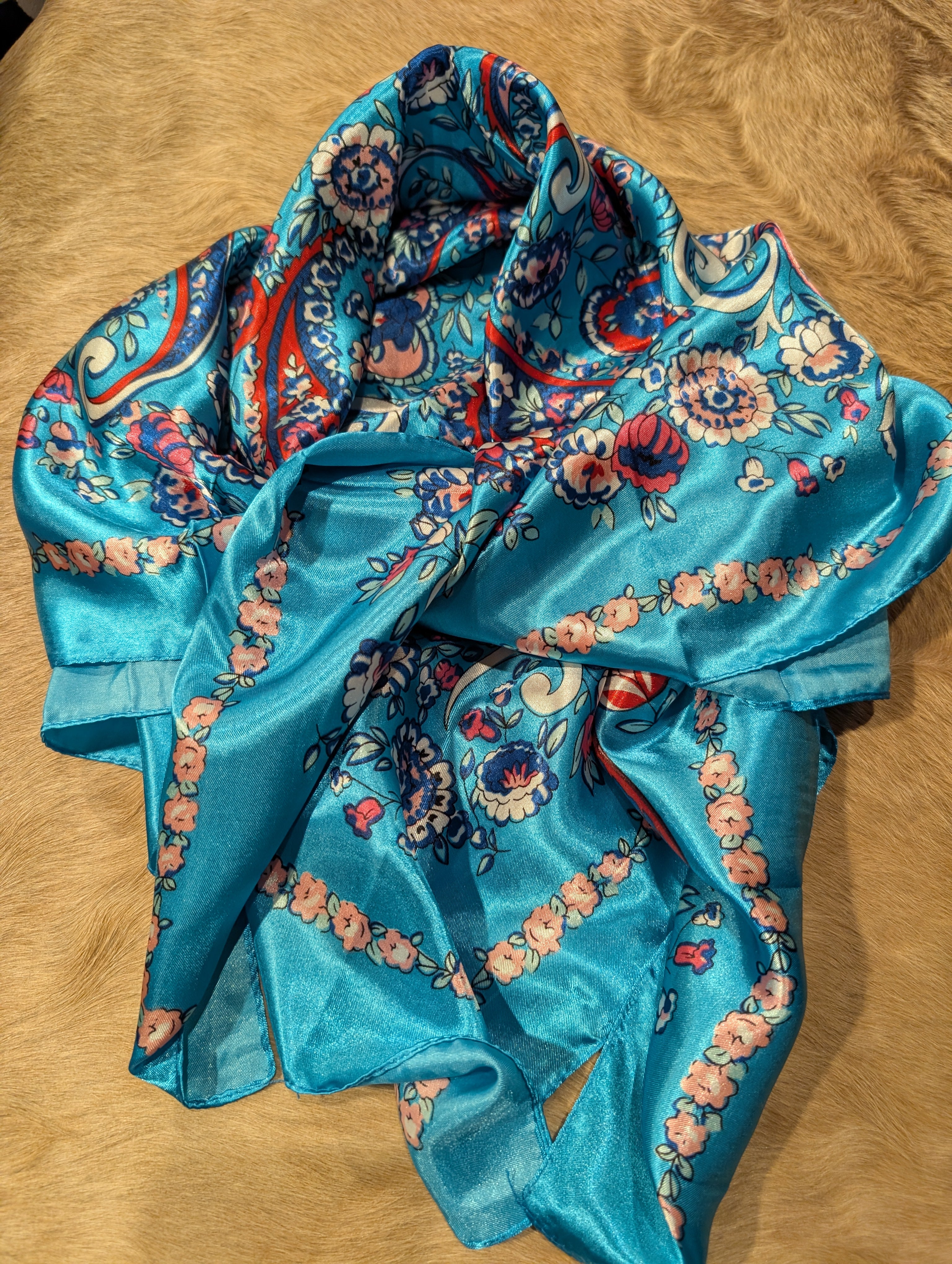 Blue floral patterned fabric on a wooden surface