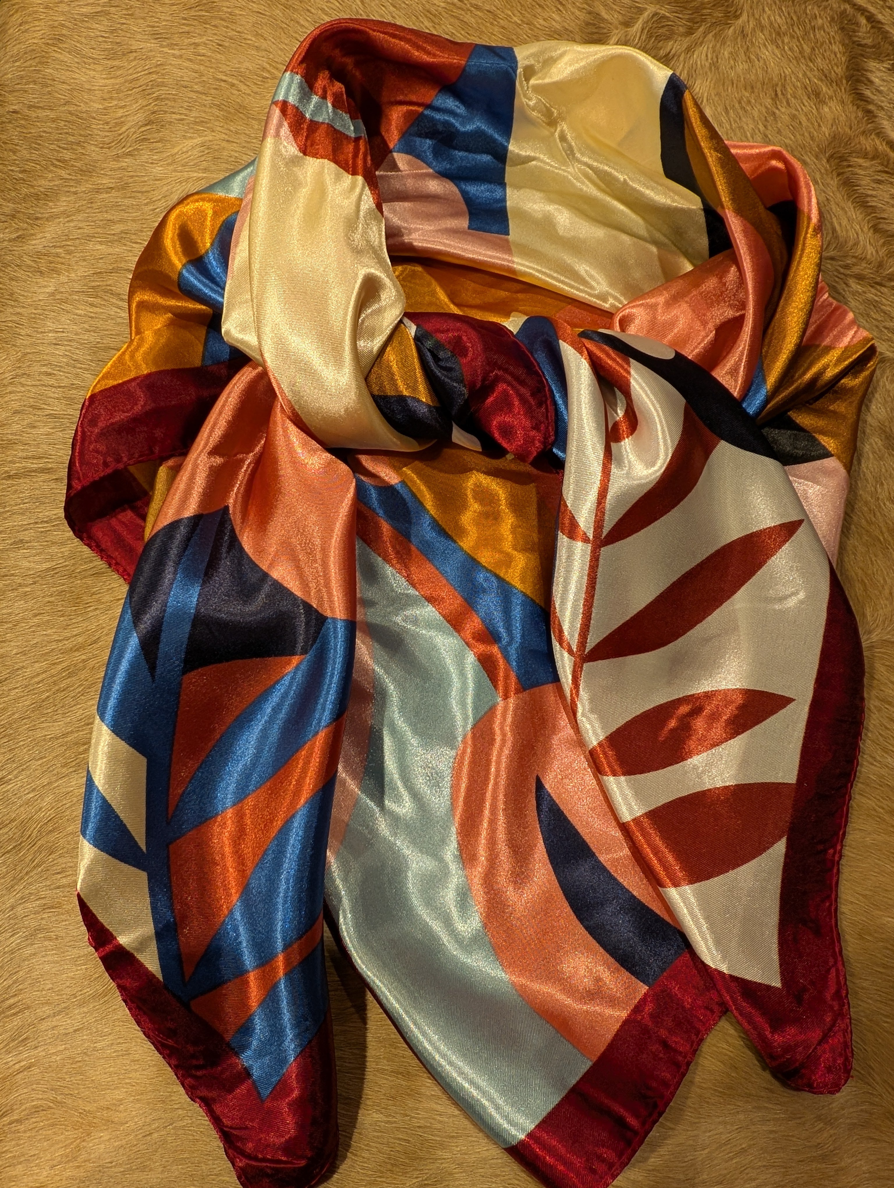 Colorful scarf on a cowhide rug