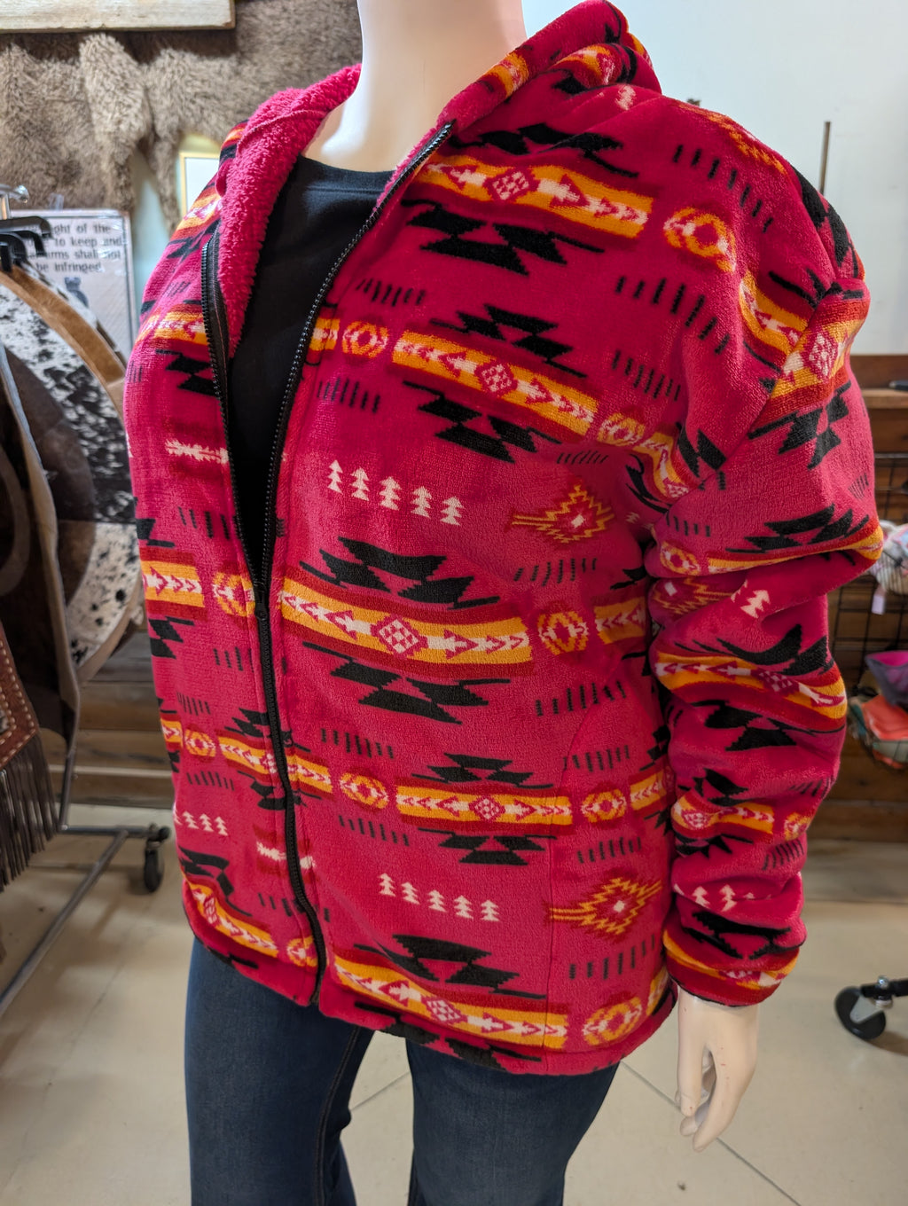 Mannequin wearing a red patterned jacket indoors