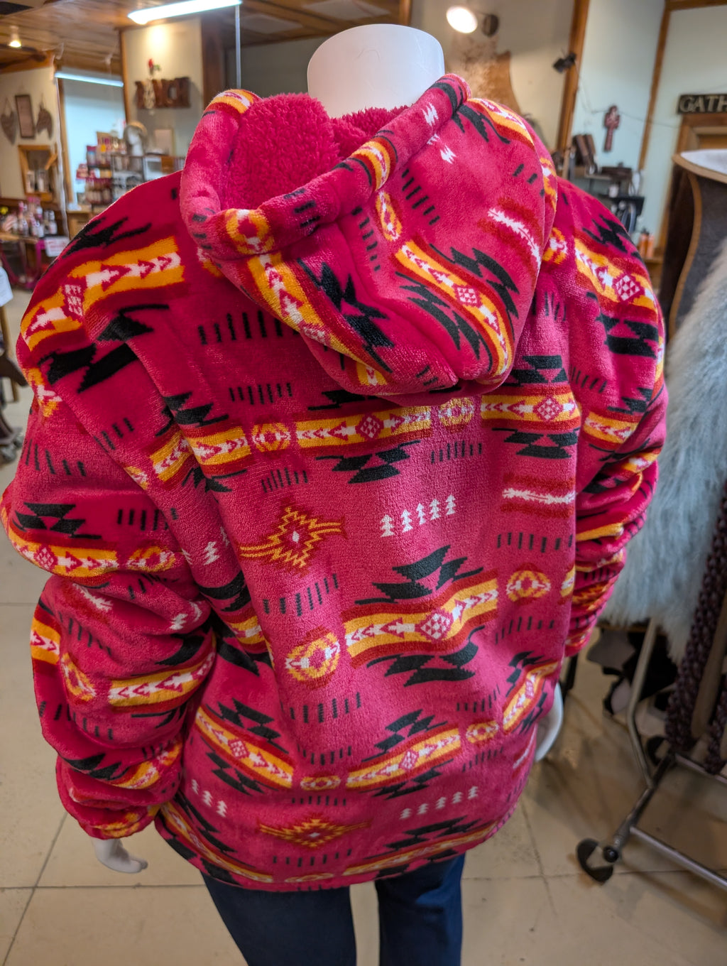 Pink patterned jacket on a mannequin in an indoor setting