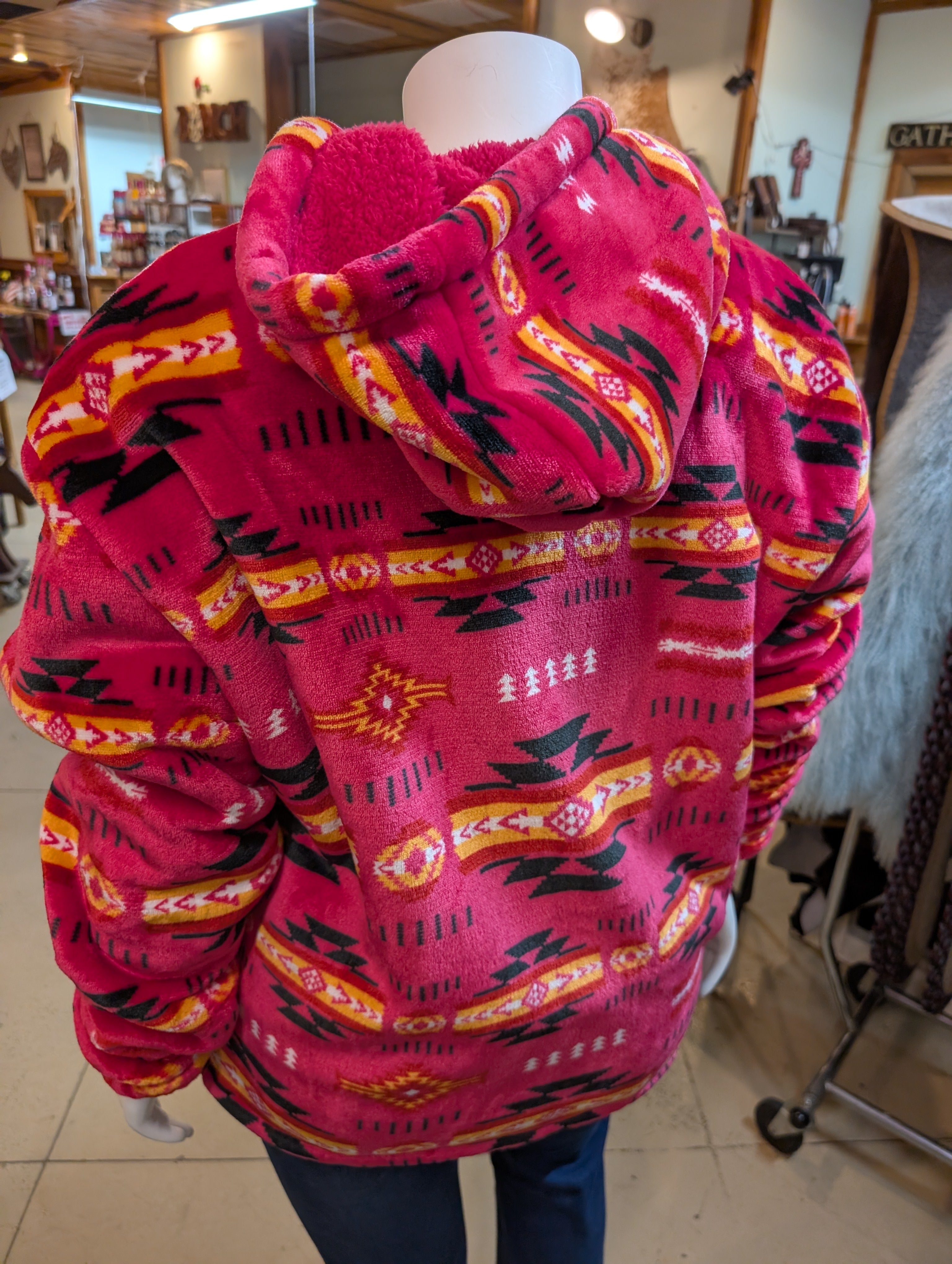 Pink patterned jacket on a mannequin in an indoor setting