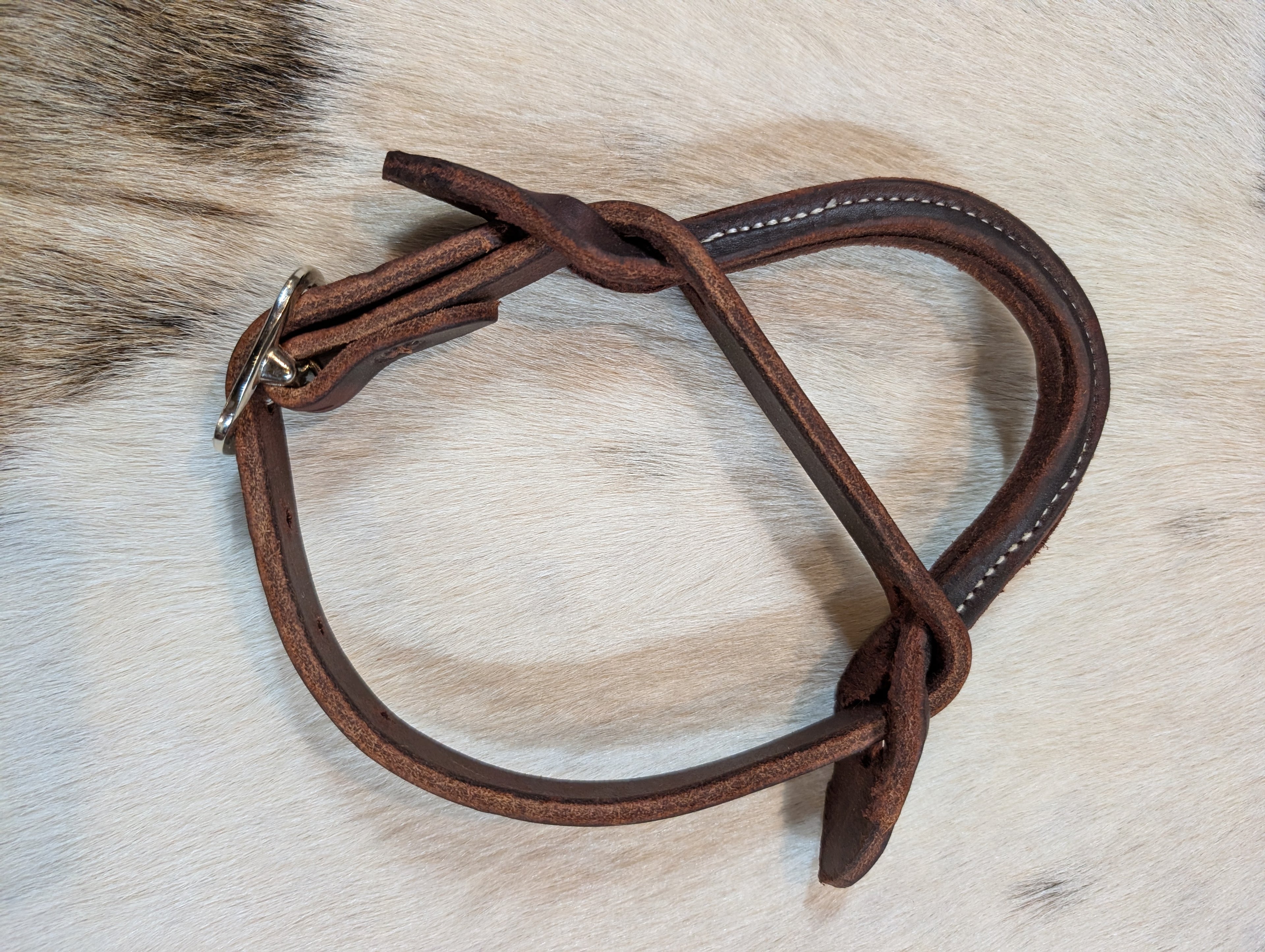 Dark leather Night Latch on a light brown fur background