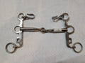 Metal horse bridle on a light gray background