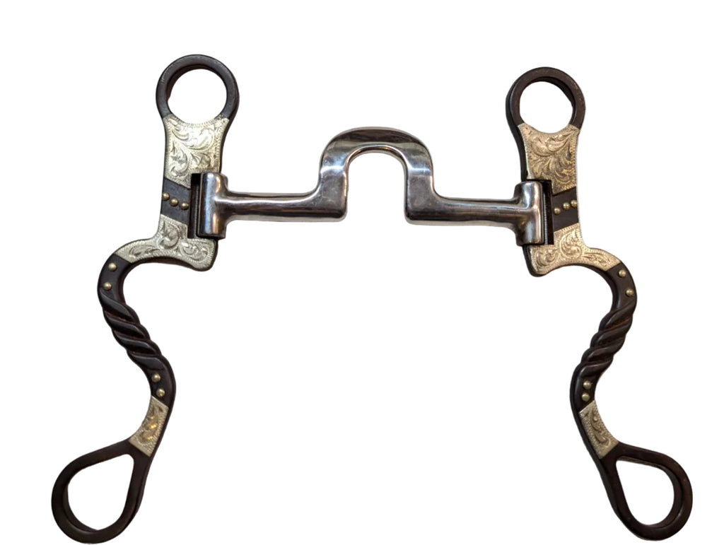 Decorative horse bridle bit with intricate designs on a light gray background