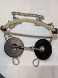 Metal bridle with black and silver components on a white background