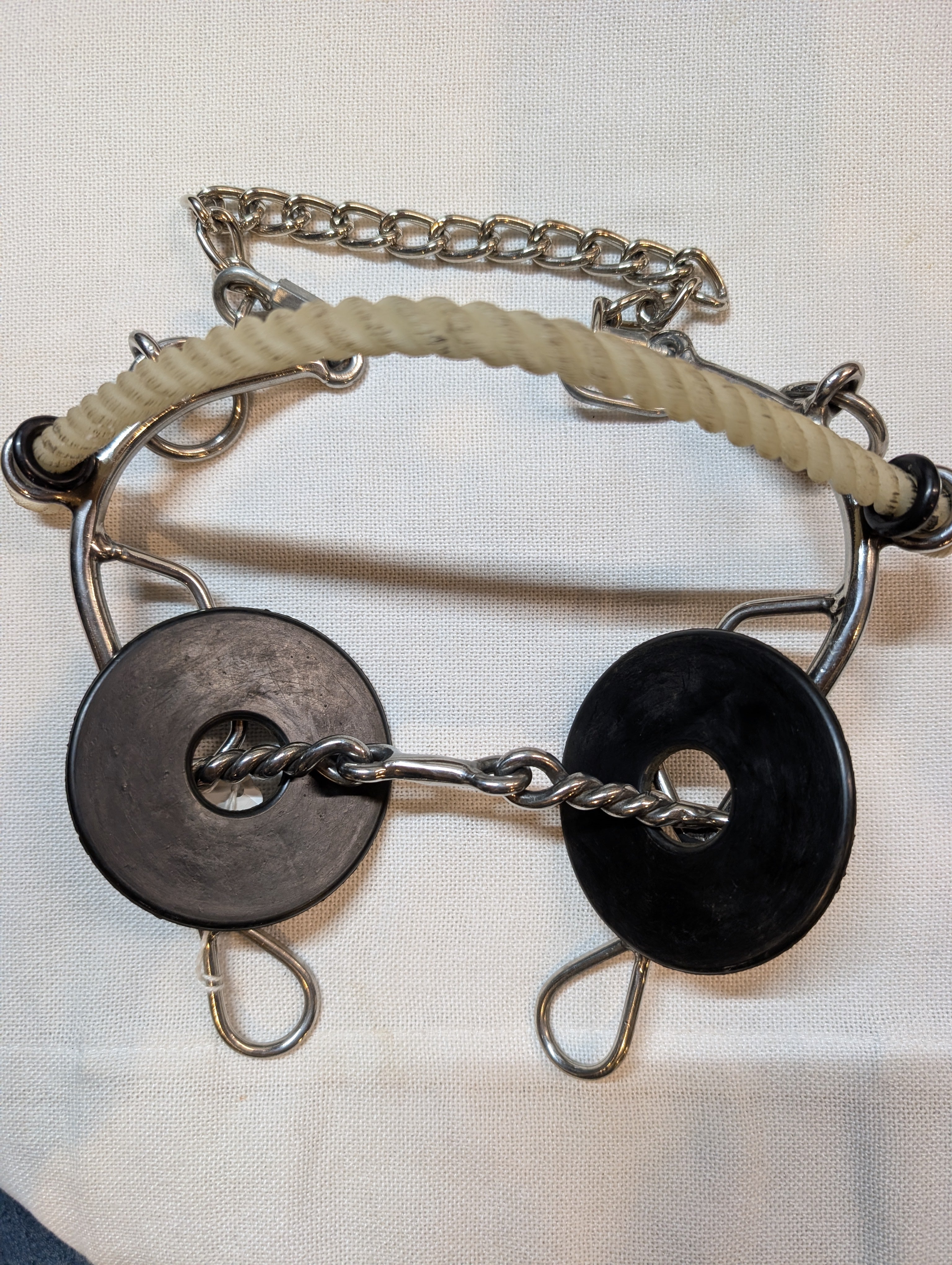 Metal bridle with black and silver components on a white background