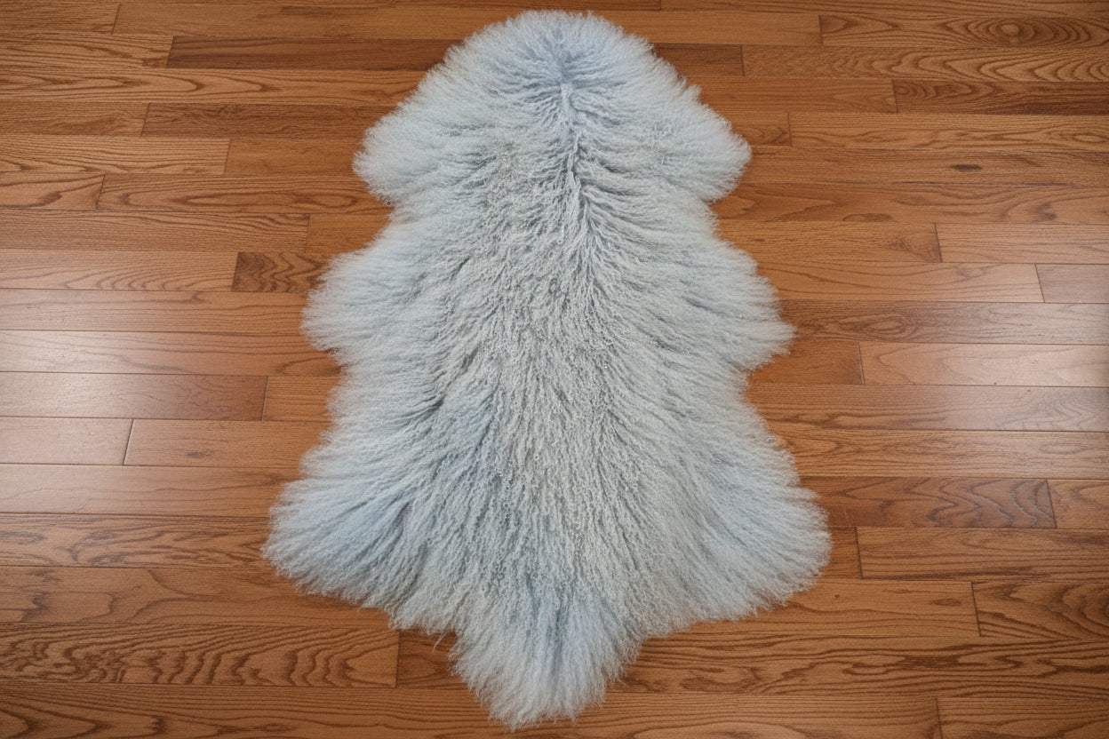 Light blue fluffy rug on a beige tiled floor