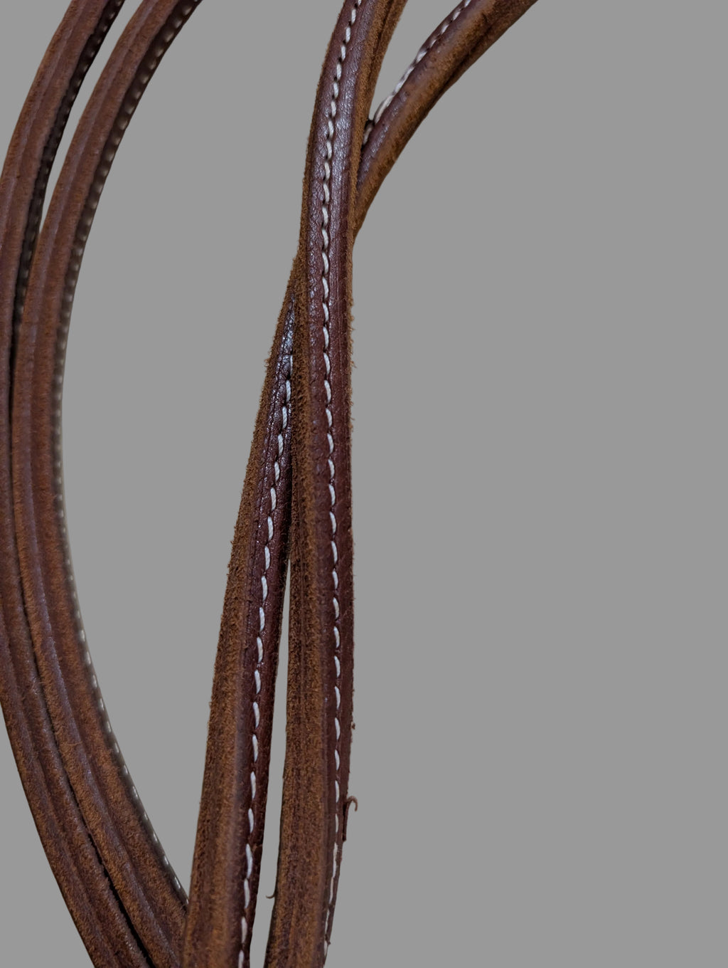 Brown leather sewn rein upclose