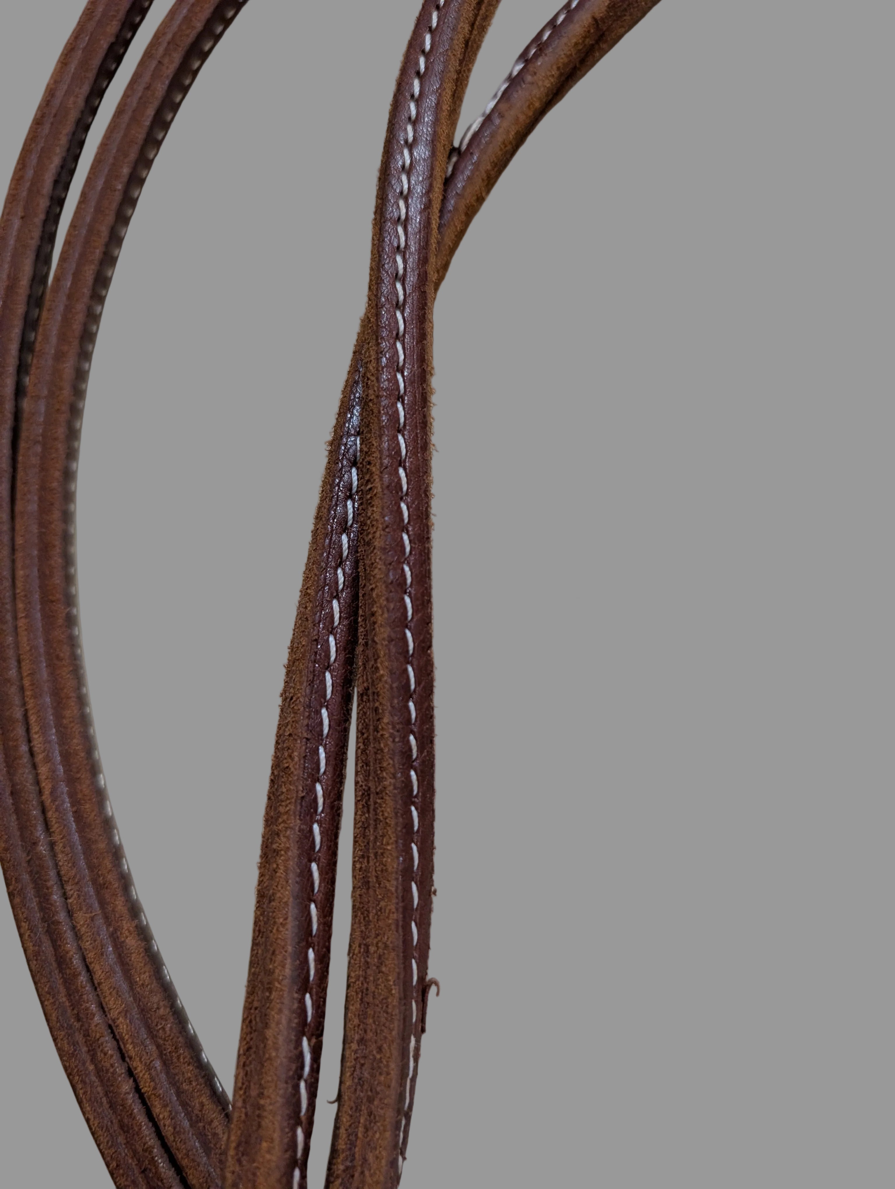 Brown leather sewn rein upclose