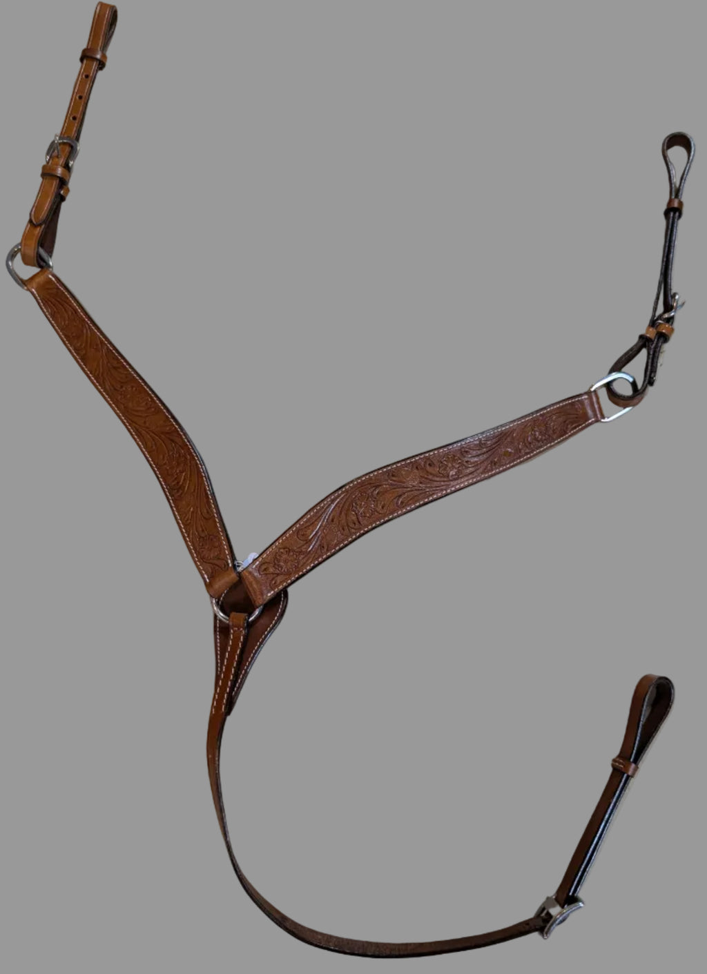 Brown leather bridle on a textured beige surface