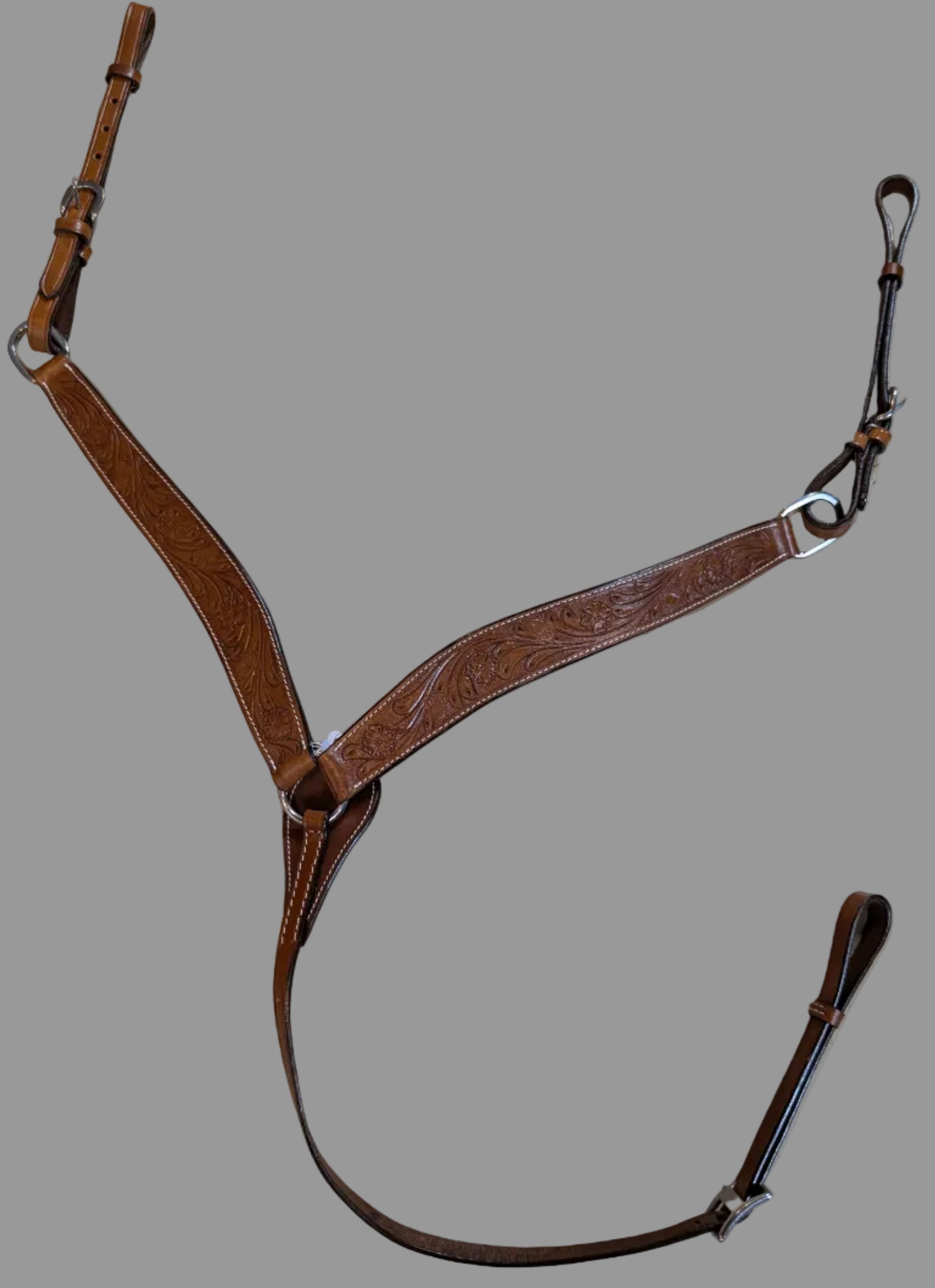Brown leather bridle on a textured beige surface