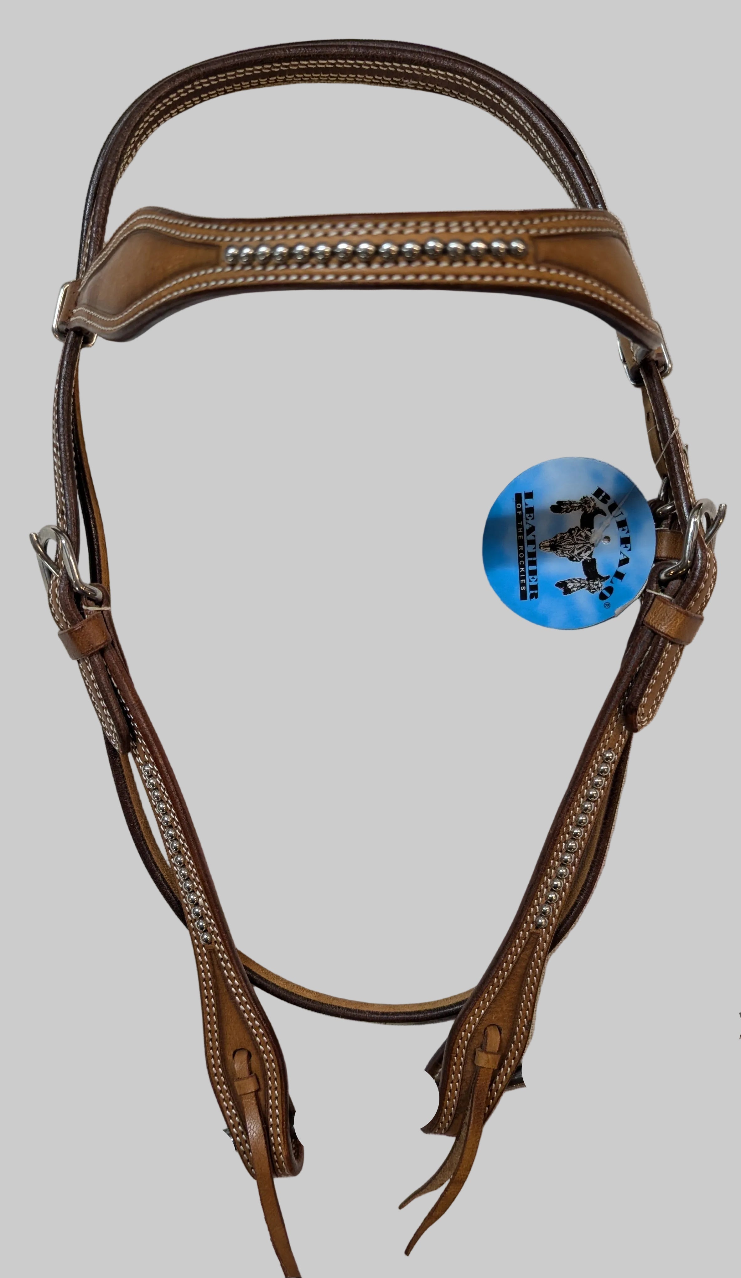 Brown leather bridle with a blue tag on a white background