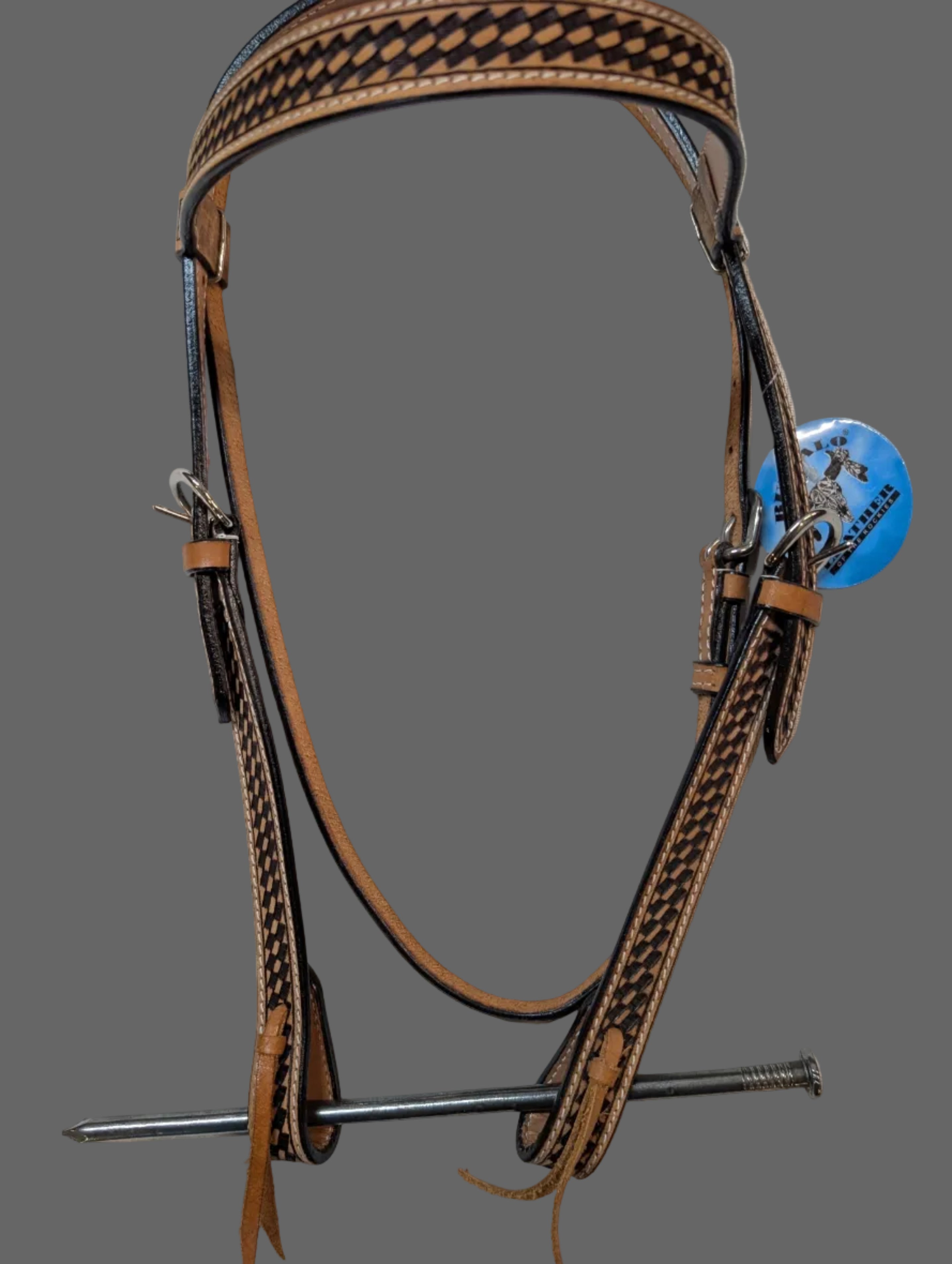 Brown leather bridle with metal bits on a white background