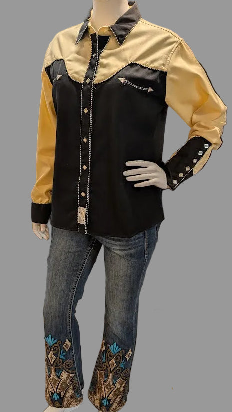 Mannequin wearing a black and yellow shirt with blue jeans with a grey background