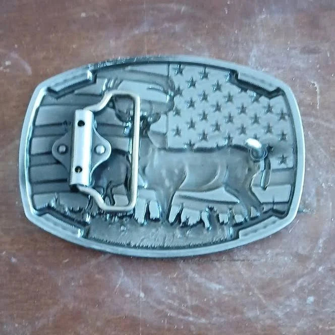Belt buckle back with American flag and deer design on a wooden surface