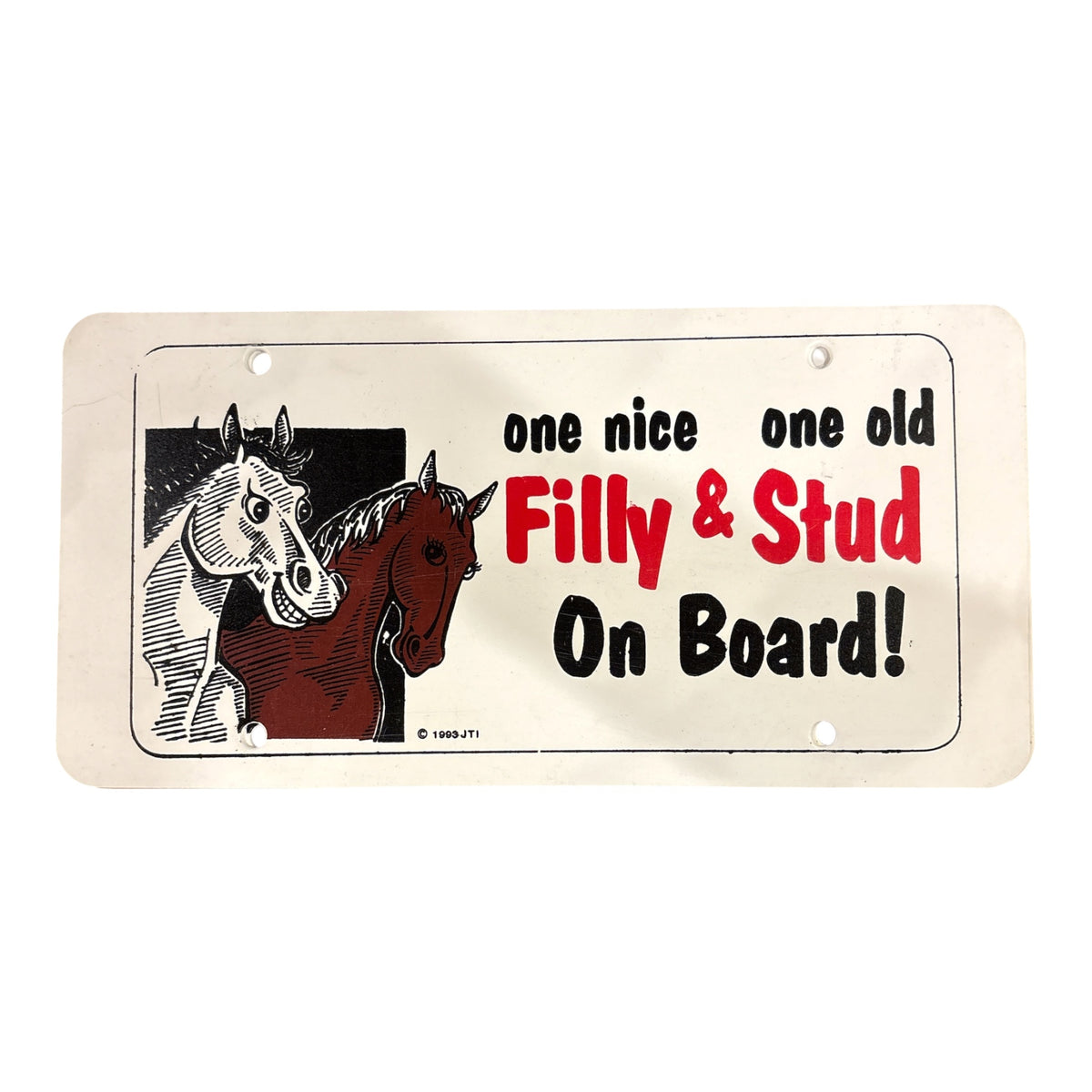 A plastic licence plate with animated horses and wording saying "One nice one old filly & stud on board!"