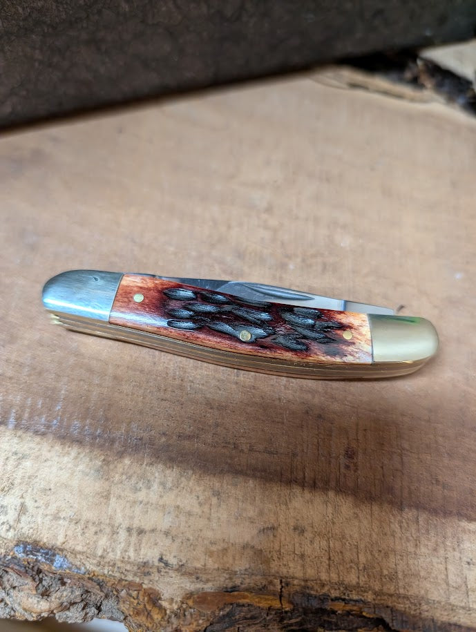Pocket knife with a decorative handle on a wooden surface